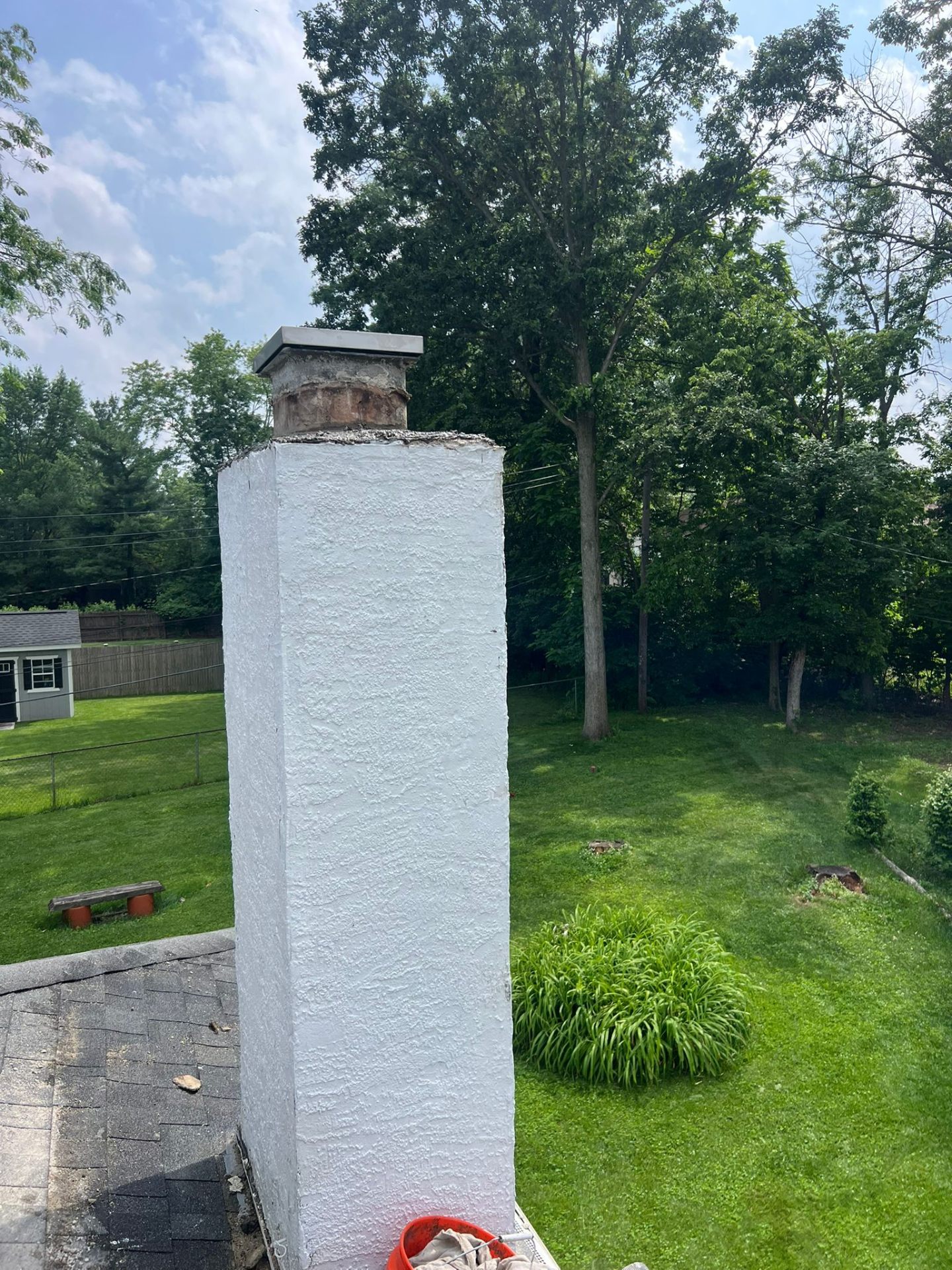 Freshly waterproofed and coated chimney with new cap