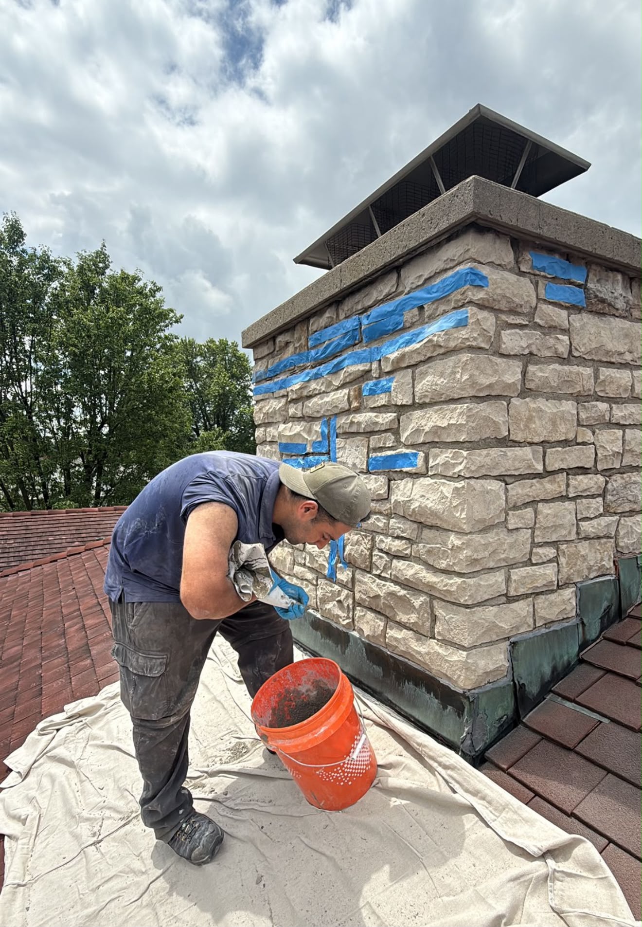 ChimCrew mason tuckpointing a stone chimney