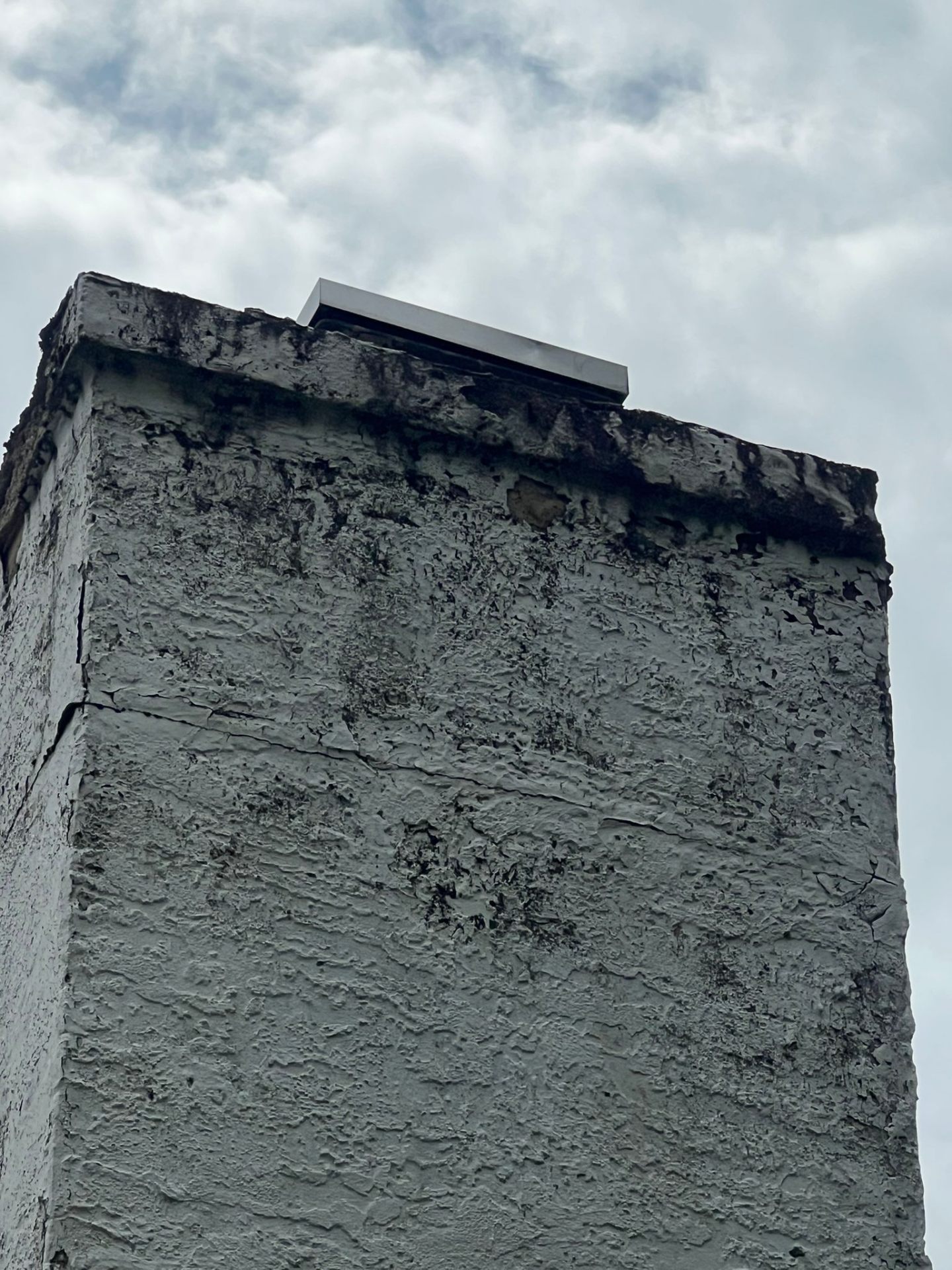 Spalling painted stucco → fresh elastomeric coat — before