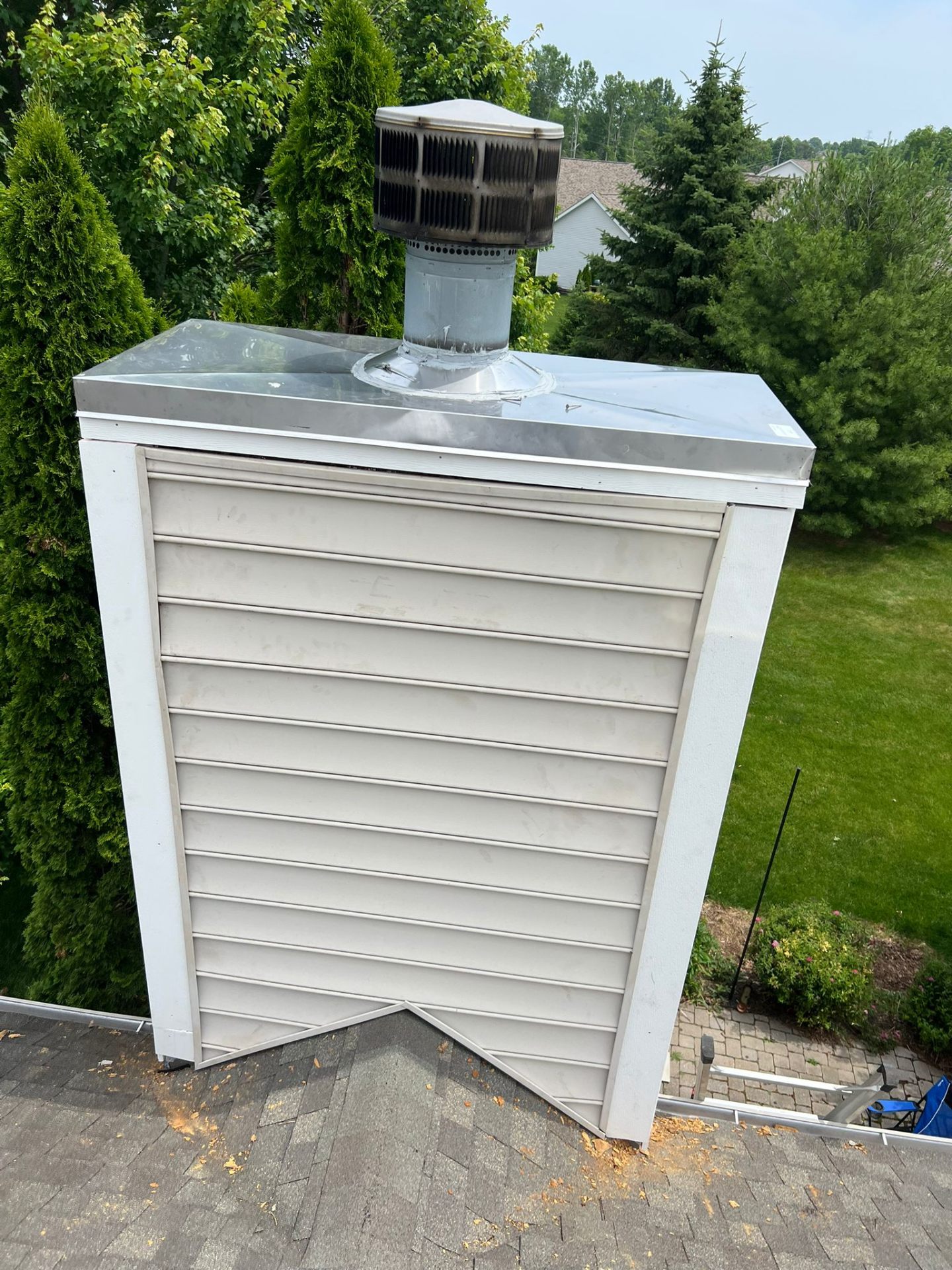 Custom stainless chase cover installed on a sided chimney