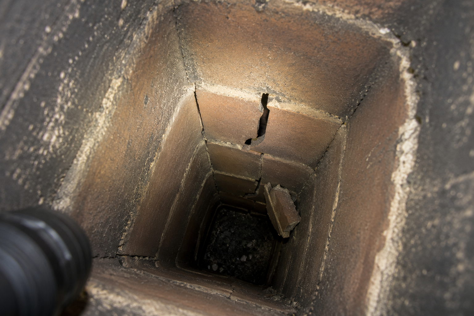 Broken clay flue liner tiles inside a chimney