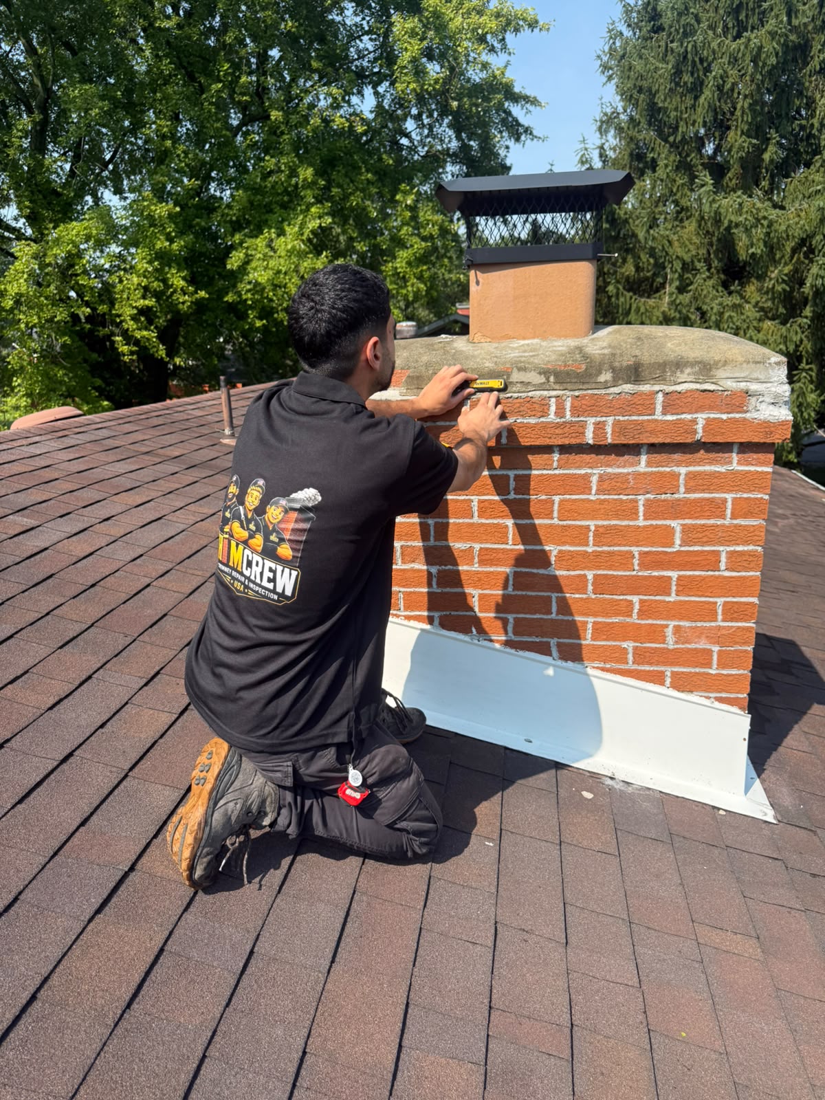 ChimCrew tech measuring a chimney crown before repair