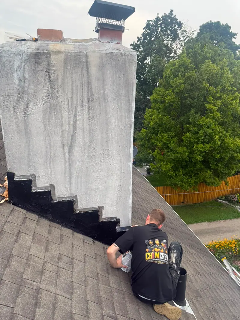 Chimcrew - Chimney Sweep & Repair crew member waterproofing a chimney and sealing flashing