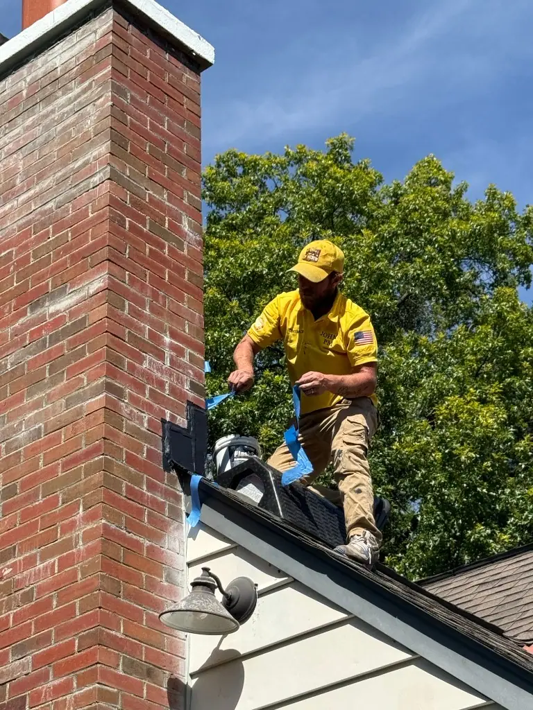Chimcrew - Chimney Sweep & Repair technician John sealing chimney flashing on a residential roof