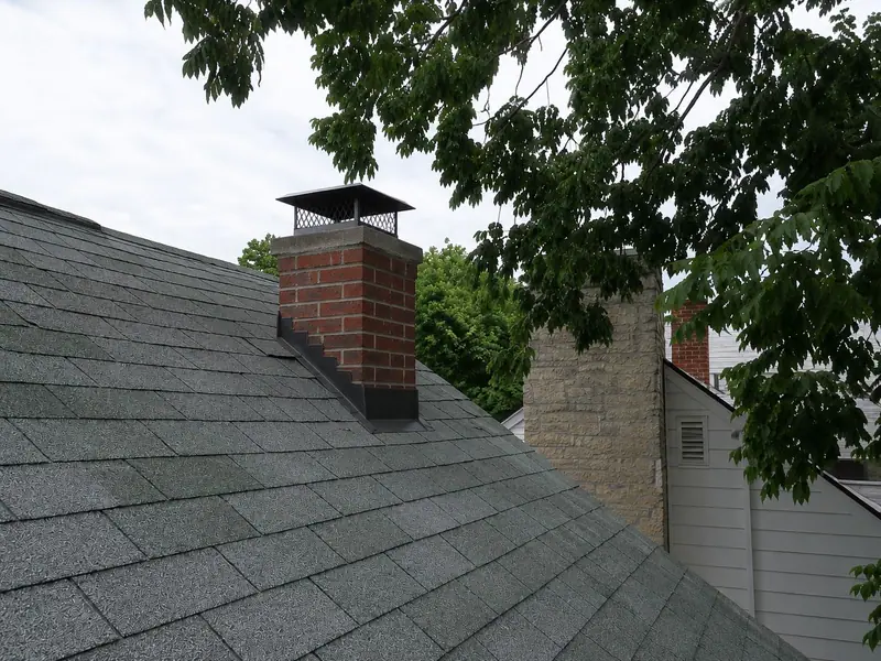 Open brick stack → capped, flashed, watertight — after